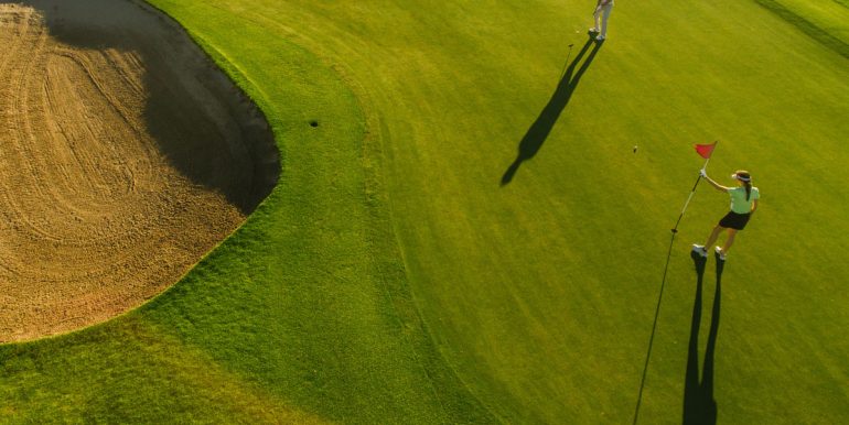 Aerial view of golfers on putting green