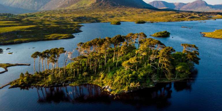 Twelve Pines Island, standing on a gorgeous background formed by the sharp peaks of a mountain range called Twelve Bens, County Galway, Ireland